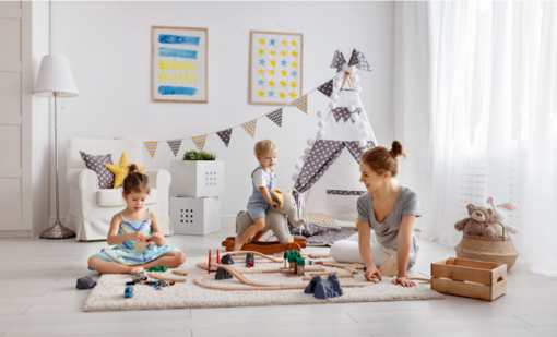 educator sitting on the floor playing with children